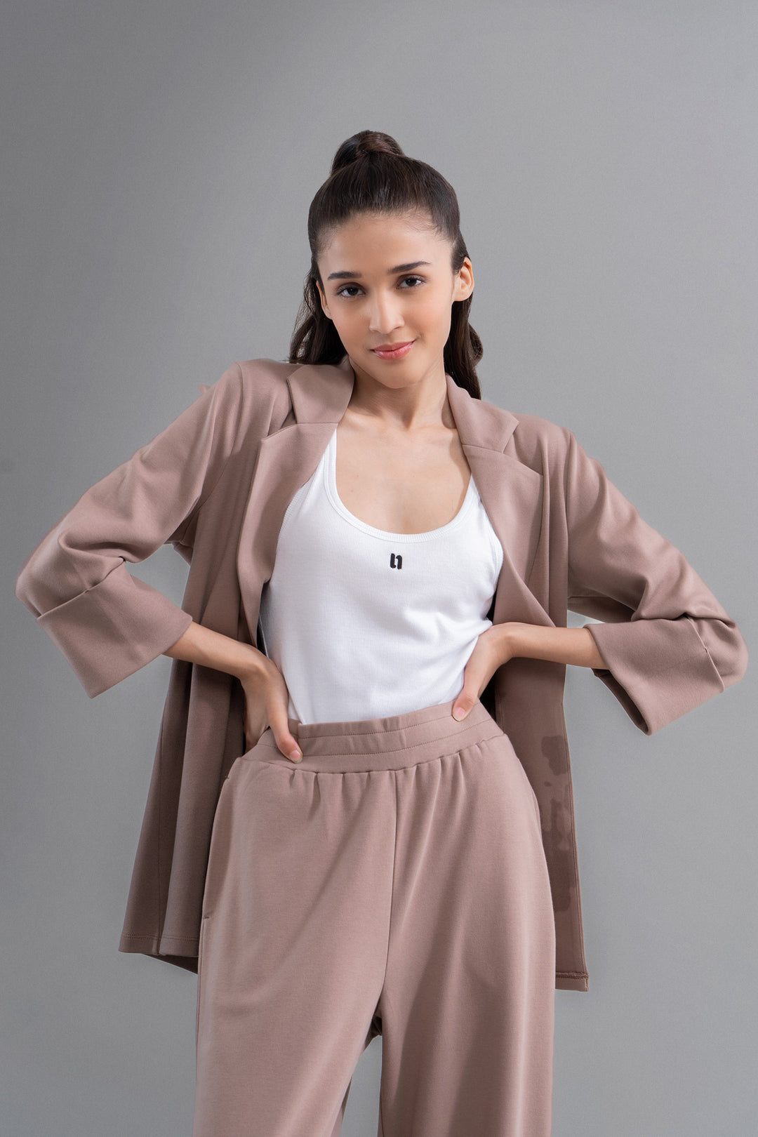 "Model showcasing Snugknit® Mocha Blazer with matching pants."