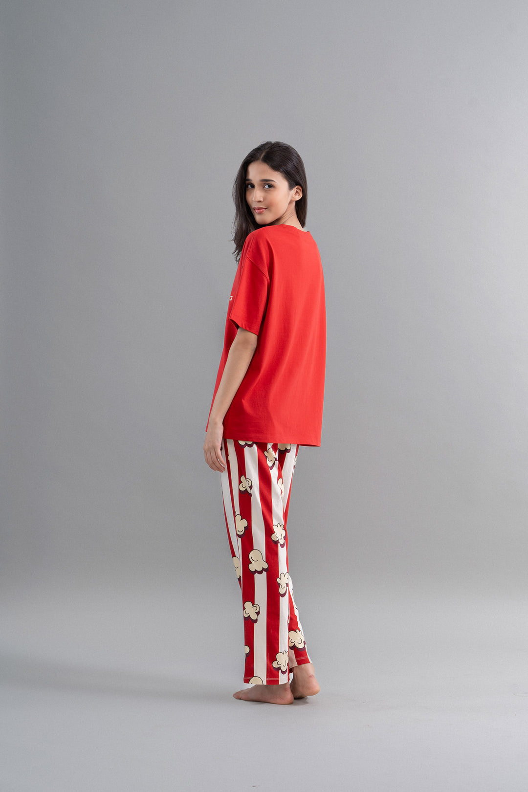 Red oversized T-shirt showcased with fun popcorn patterned pants.