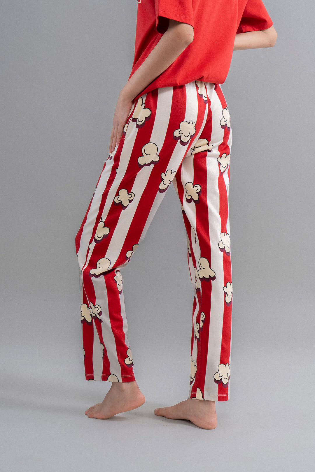 Red striped pajama pants with popcorn design for movie nights.