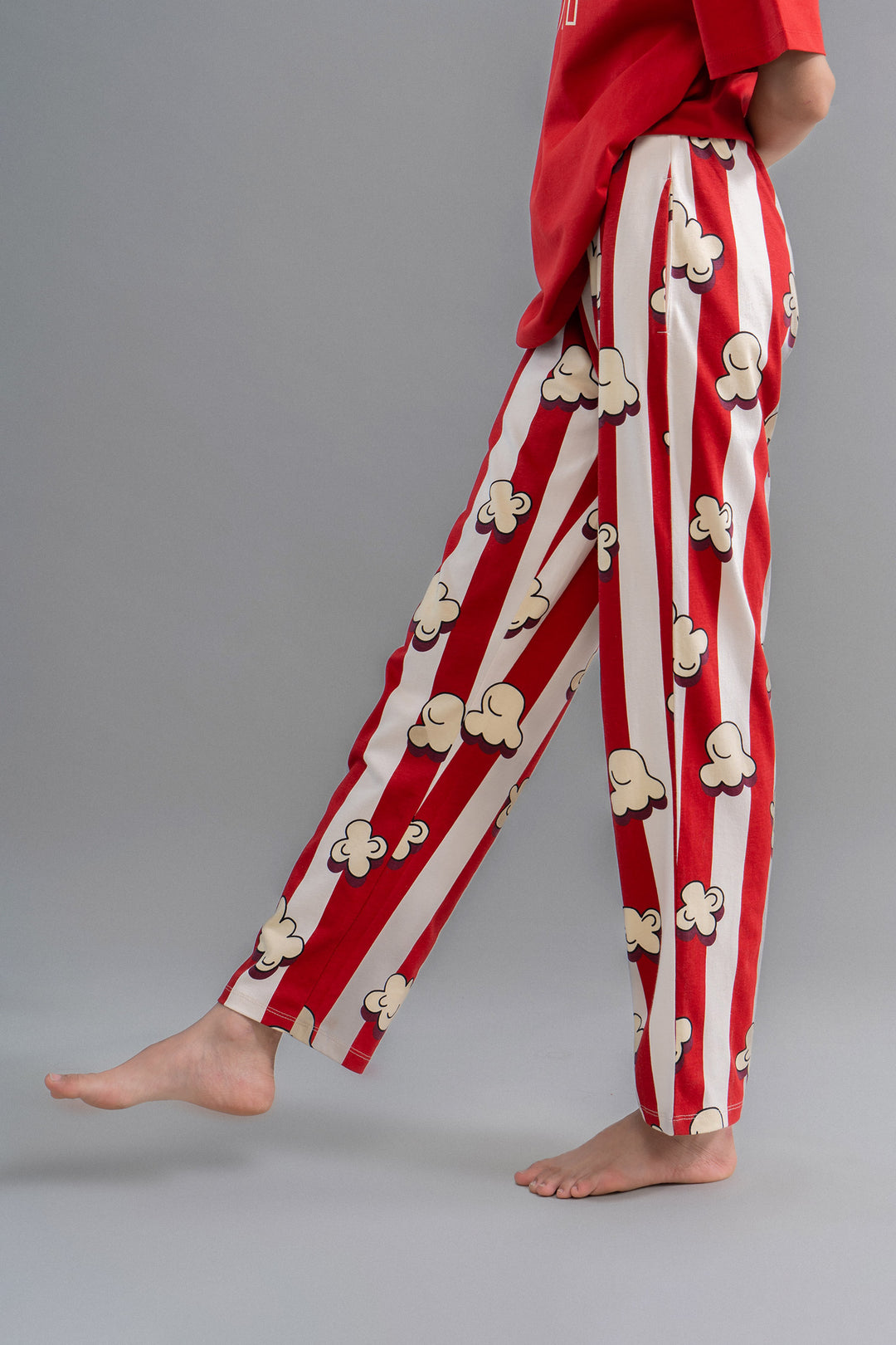 Red pajama pants with popcorn pattern, perfect for movie nights.