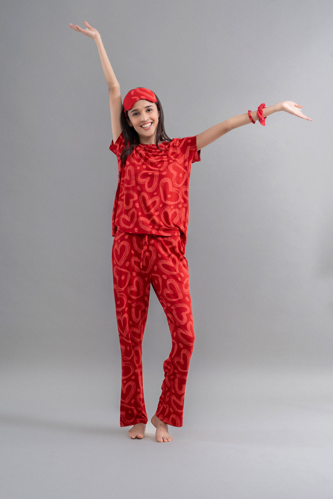 Lovestruck Hearts Red Pajama Set worn by a smiling model.