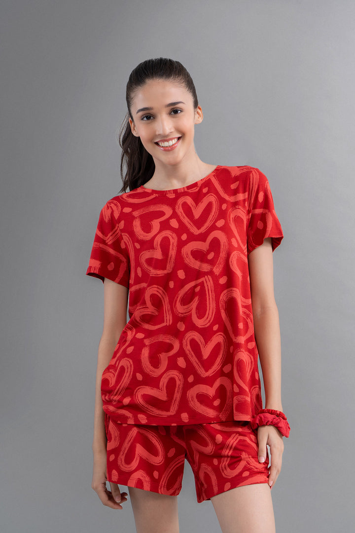 "Lovestruck Hearts Red Tee, stylish and comfy with heart patterns."