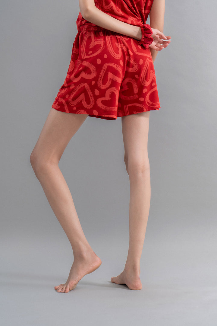 "Lovestruck Hearts Red Shorts on model, stylish and comfortable summertime attire."