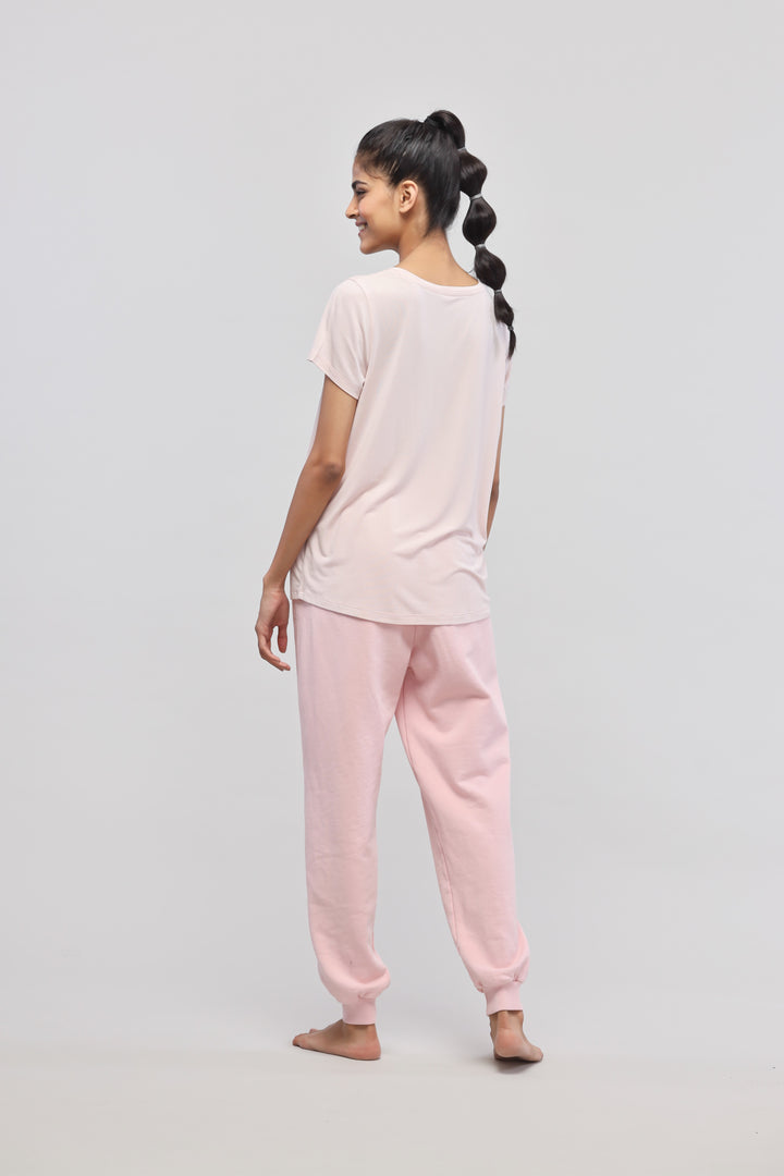 Back view of a woman in a pink terry loungewear set.