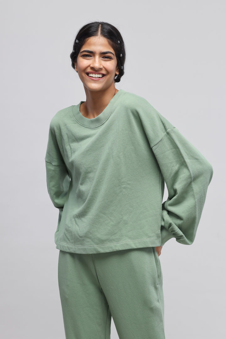 Mint green puffed sleeves terry sweatshirt styled casually with matching pants.