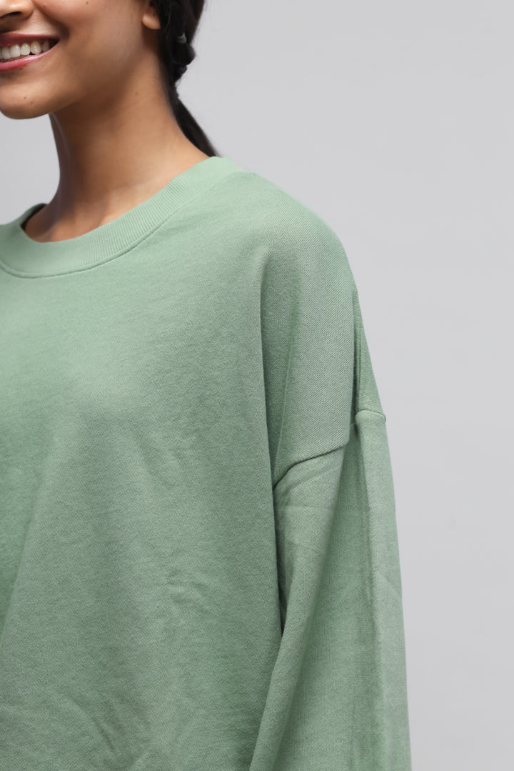 Mint green puffed sleeves terry sweatshirt on model, stylish and comfortable.