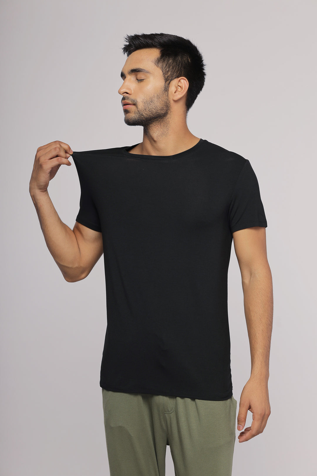 Black men's tee modeled by a man in casual attire.