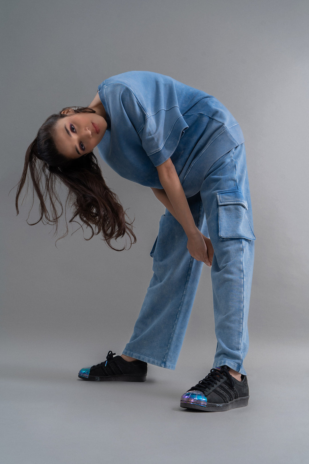 100% cotton denim terry cargo pants modeled by a woman.