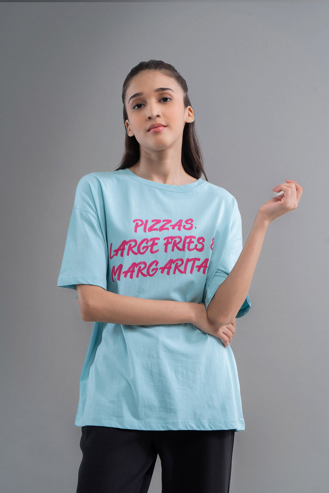 Model wearing an oversized top featuring pizza-themed graphic design.