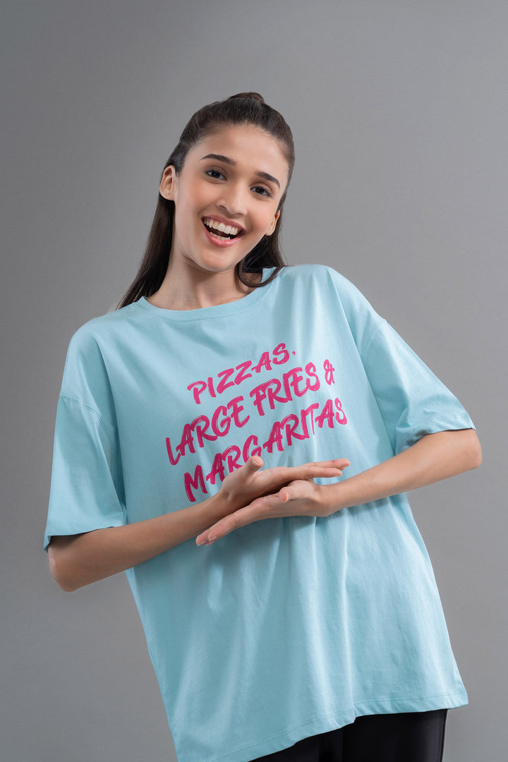 Smiling model wearing oversized top with fun food-themed graphic design.