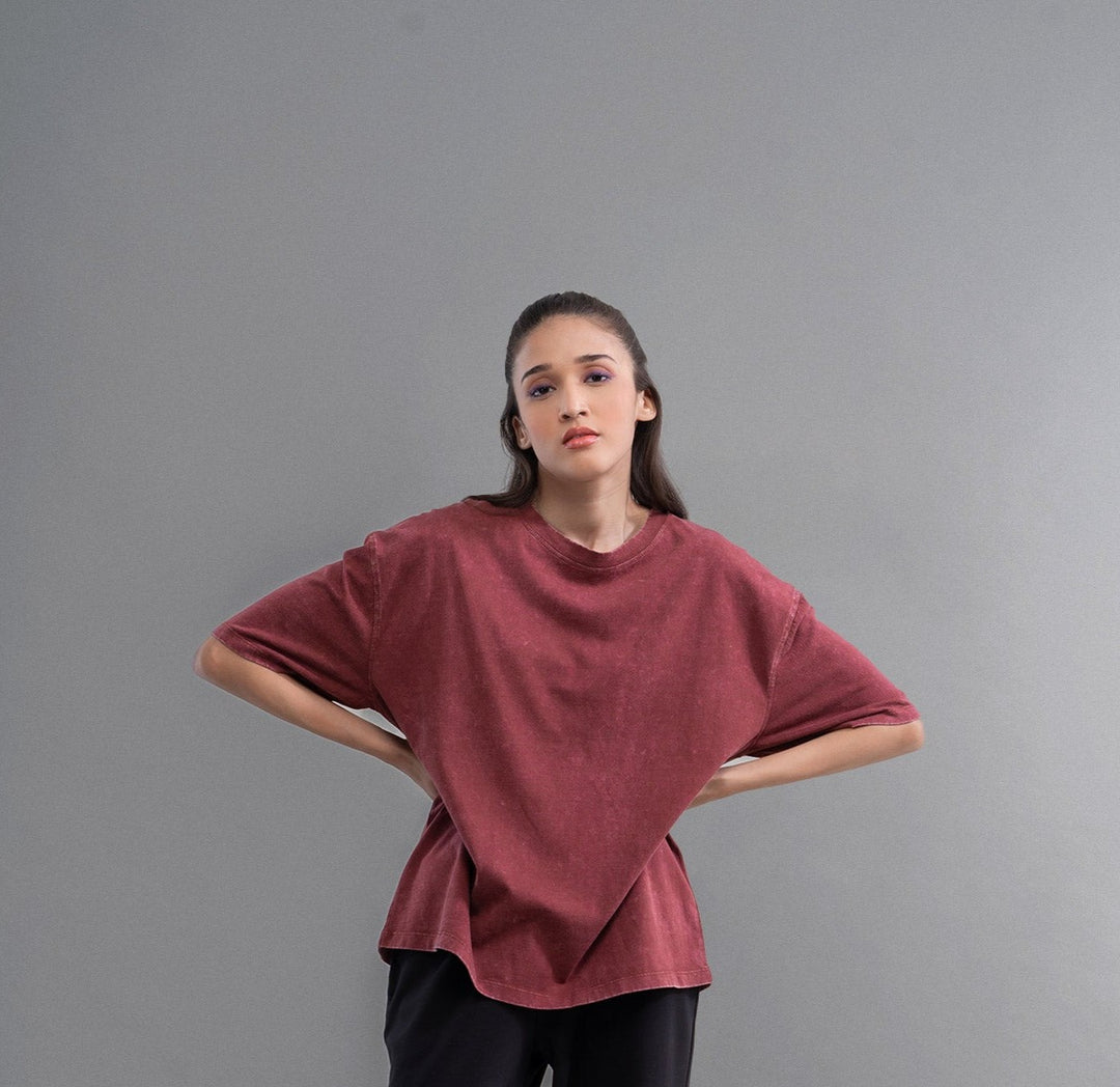 Burgundy acid wash unisex t-shirt worn by a model.