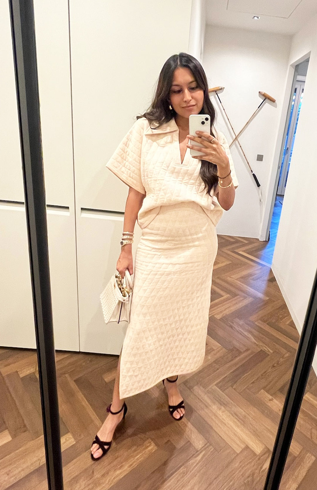 Quilted white skirt set worn by a woman in a mirror selfie.