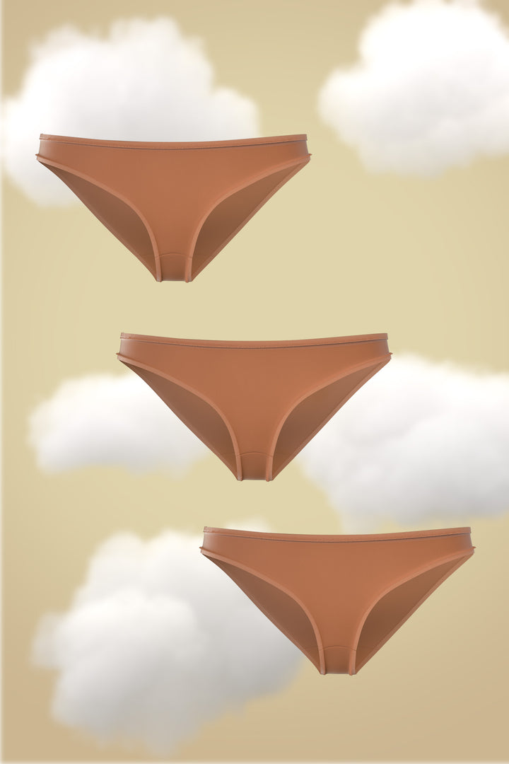 Set of three Bikini-Warm Ember Supima Modal Nessies displayed against a soft cloud backdrop.