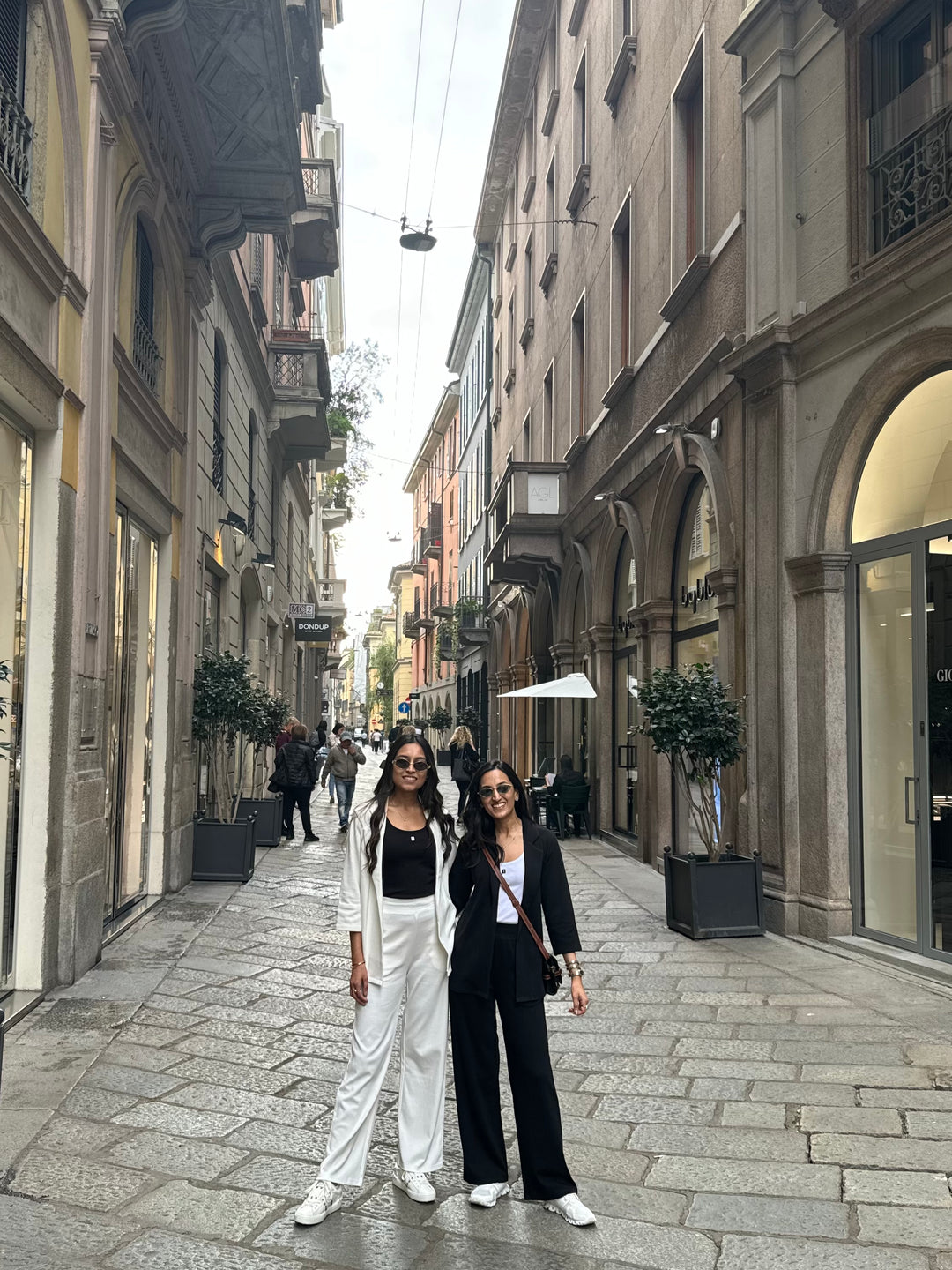 Stylish women wearing Snugknit Black Blazer Set in a fashionable street.