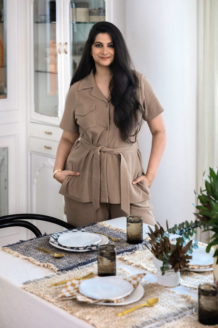 Elegant woman showcasing Safari Lushknit® 2.0 Set at a styled dining table.