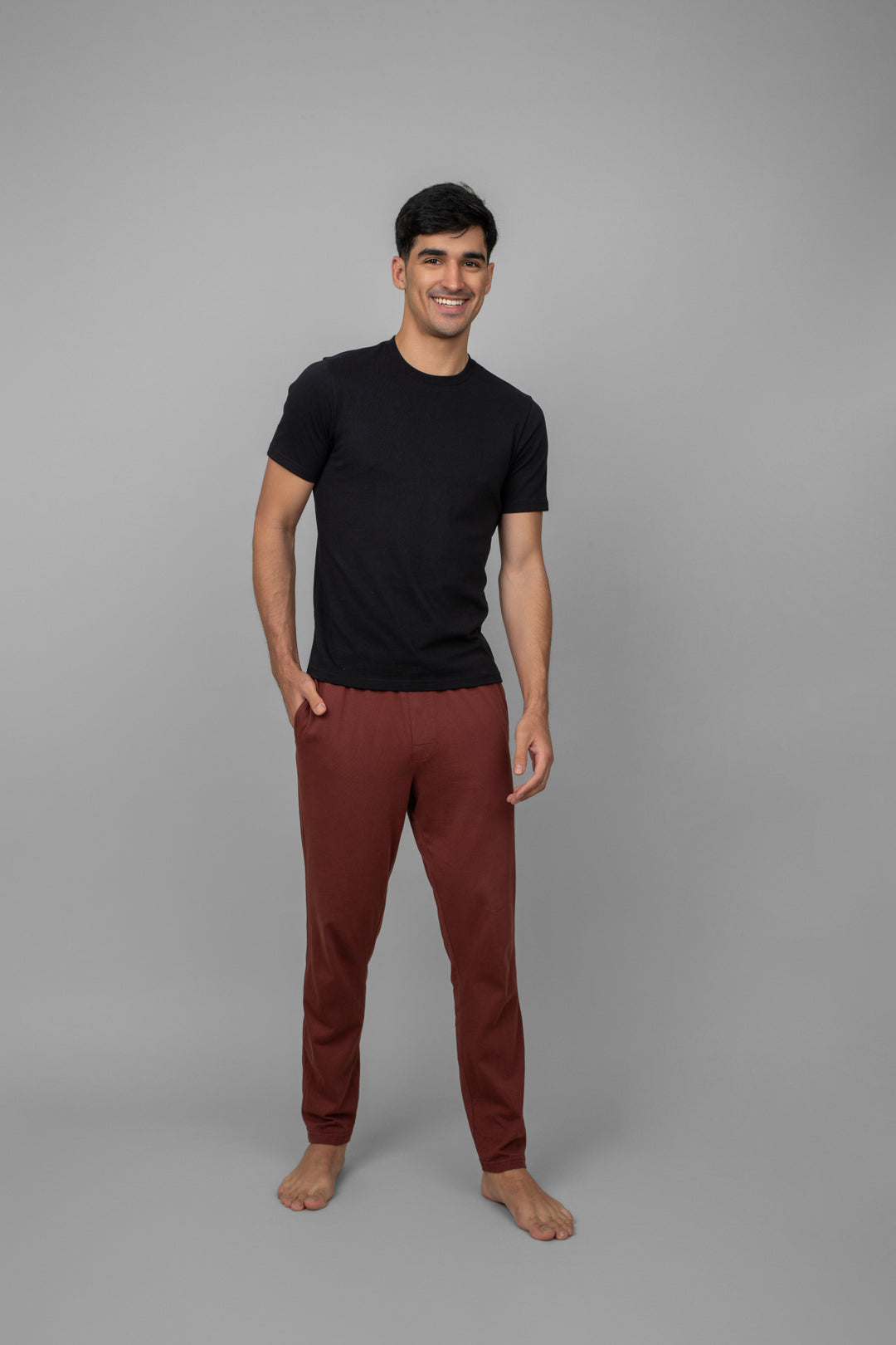 Burgundy men's pajama set displayed on model with black t-shirt.