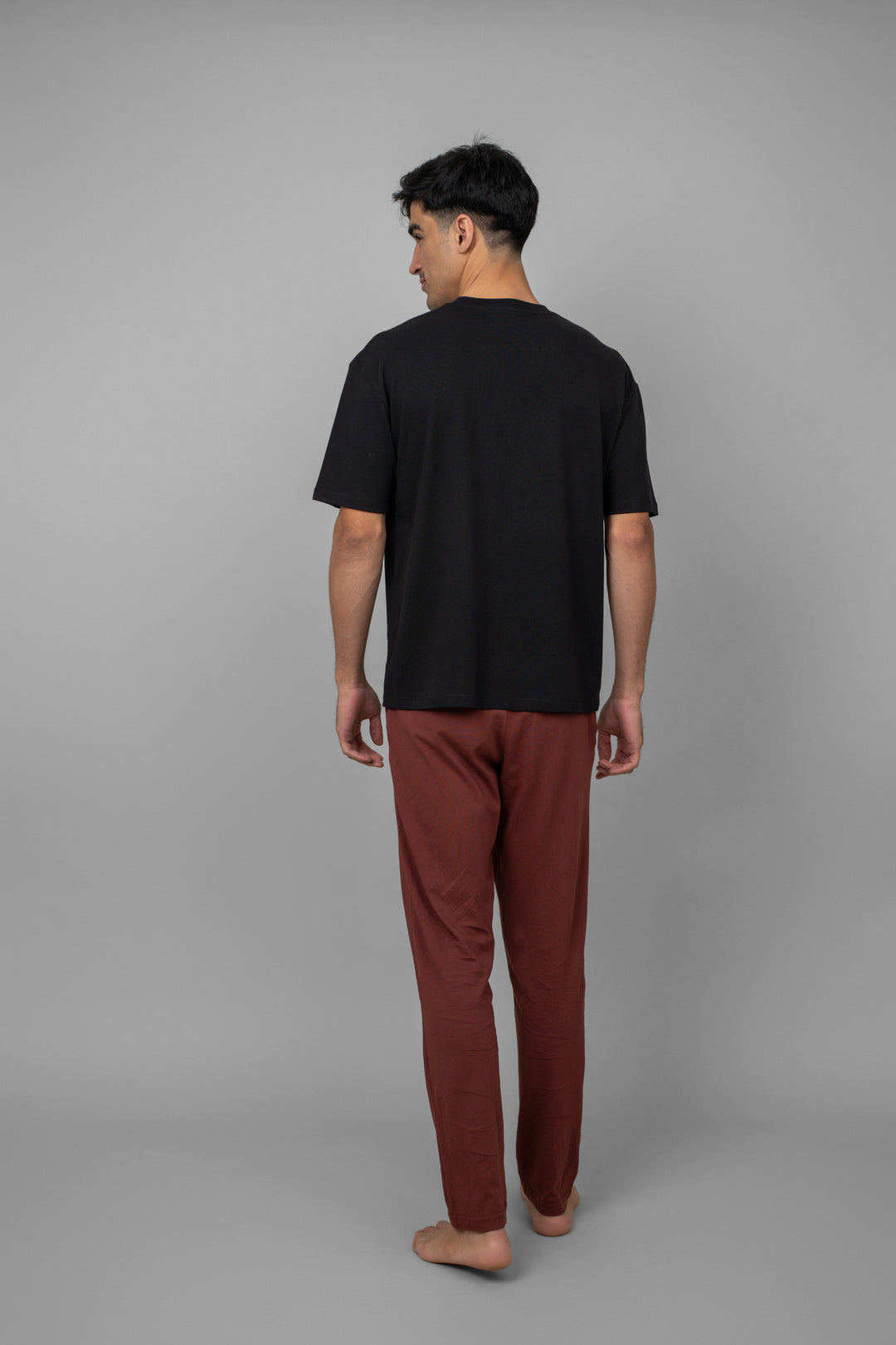 Burgundy mens pajama set featuring a black top and burgundy pants.