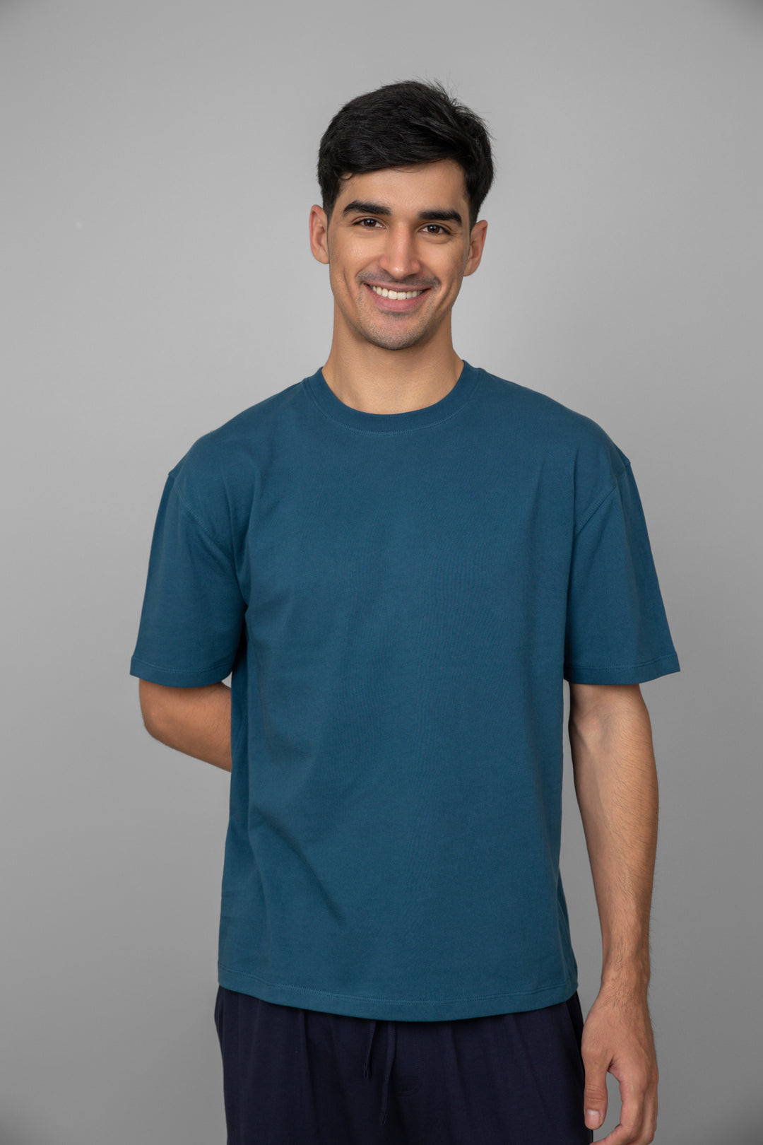 Dark navy men's pajama set on a smiling model.