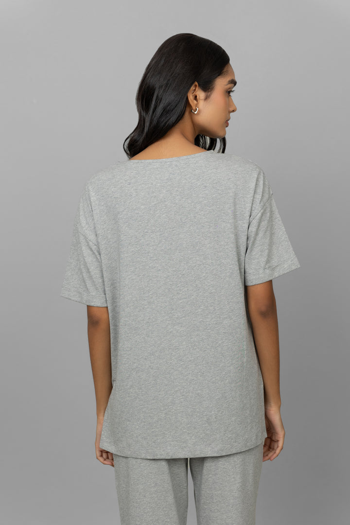 Back view of a woman in a grey mélange long top.