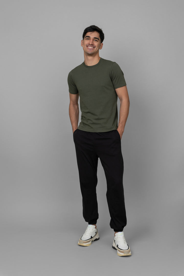 Green men's jogger set featuring a t-shirt and black pants.