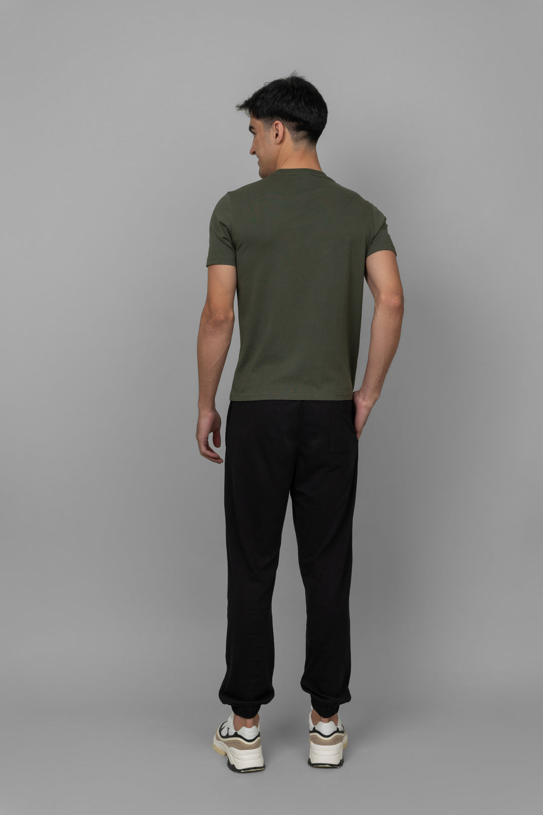 Black men's joggers worn with a casual t-shirt from the back.