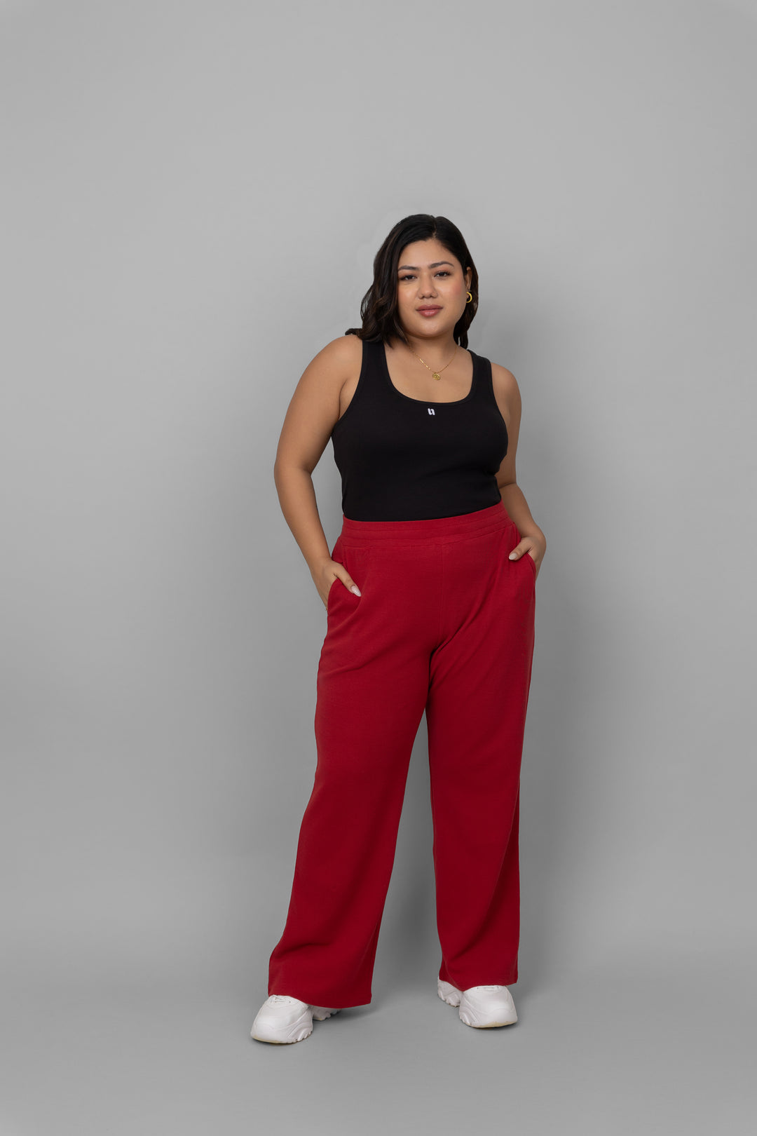 Model wearing a black rib jogger set with red pants.