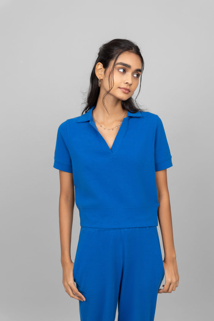 Blue mini waffle polo shirt on a model. Stylish and modern design.