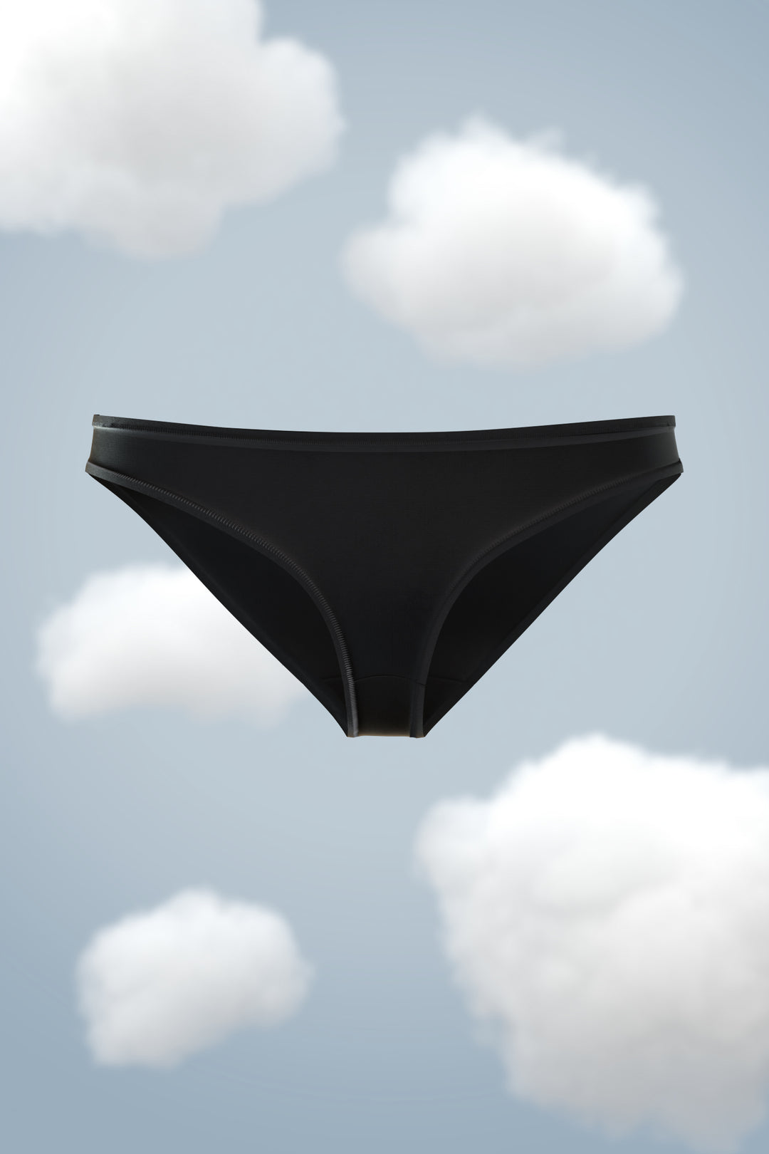 Supima Modal Bikini Nessies in sleek black against a cloudy sky background.