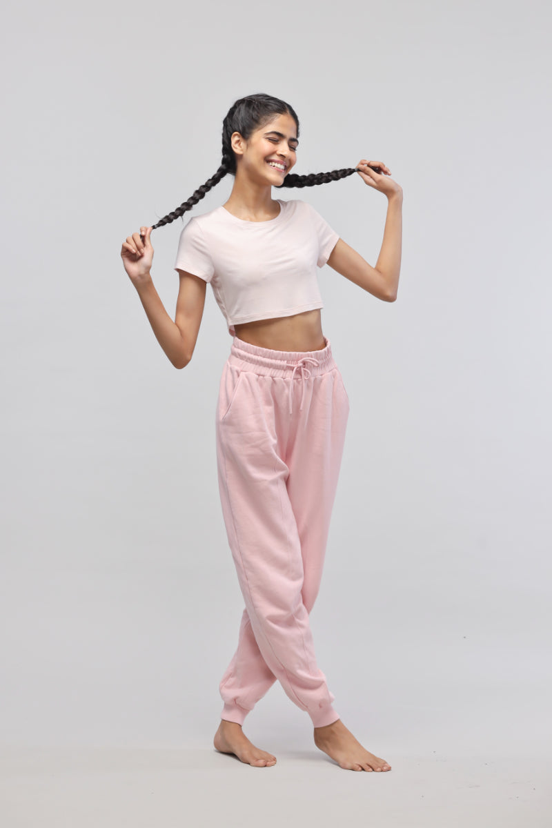 Light pink crop top paired with cozy pink sweatpants.