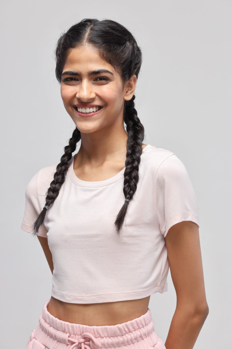 Smiling model wearing light pink crop top from Pink Terry Set.