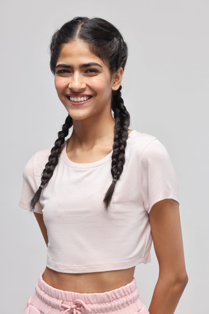 Smiling model wearing light pink crop top from Pink Terry Set.