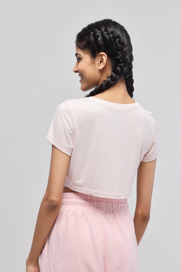 Light pink crop top for casual and trendy outfits.