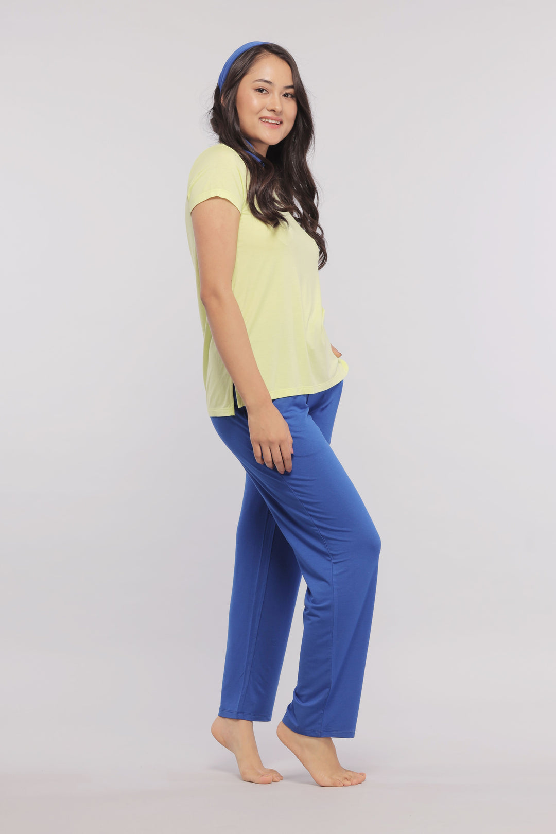 Woman wearing Rise And Run Flared Lounge Set in yellow and blue.