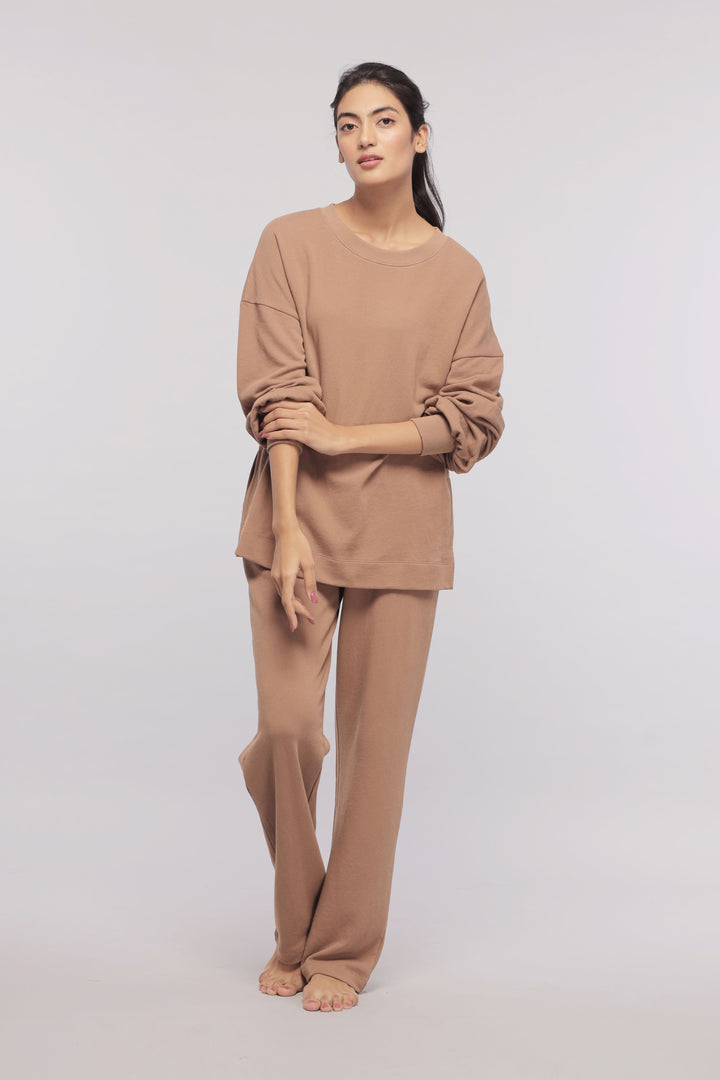 Brown terry long sweatshirt styled with matching pants on a model.