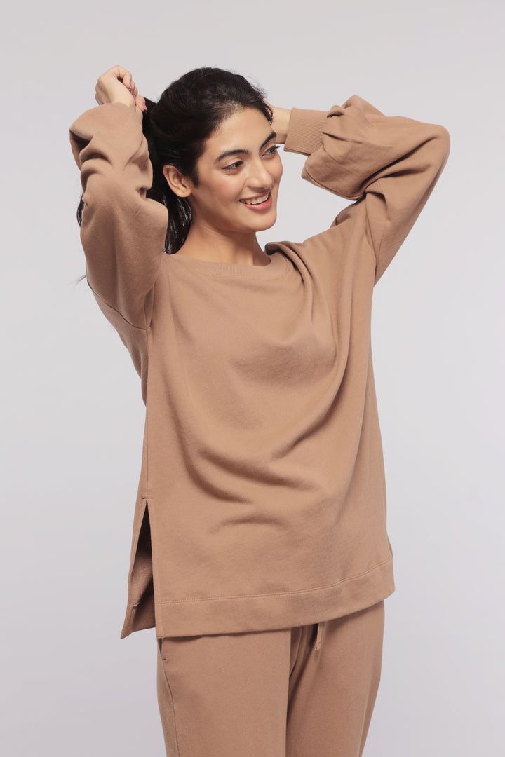 Smiling woman in brown terry long sweatshirt hairstyle styling.