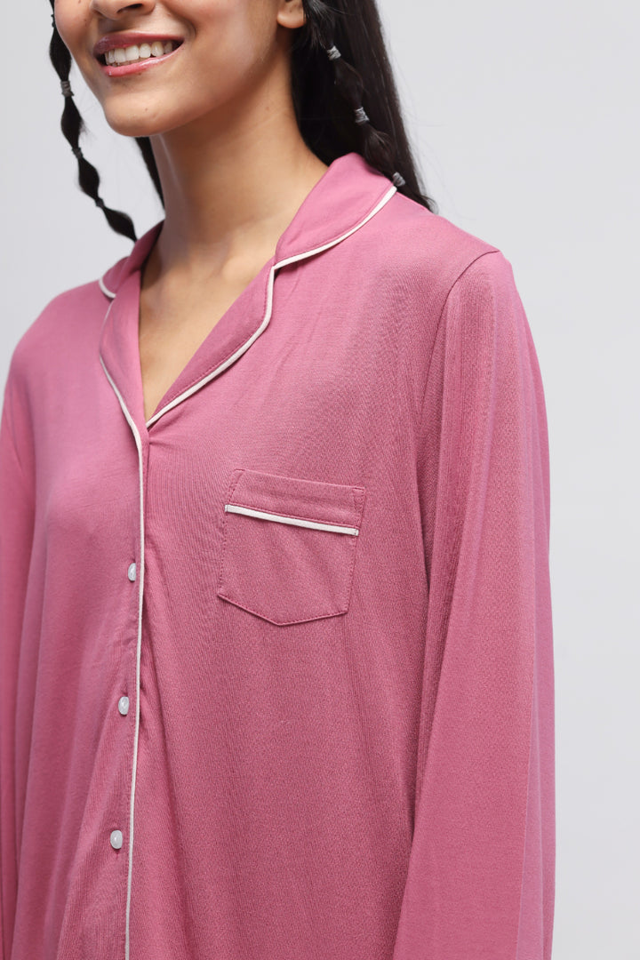 Rosy pink button-down top with piping and full sleeves.