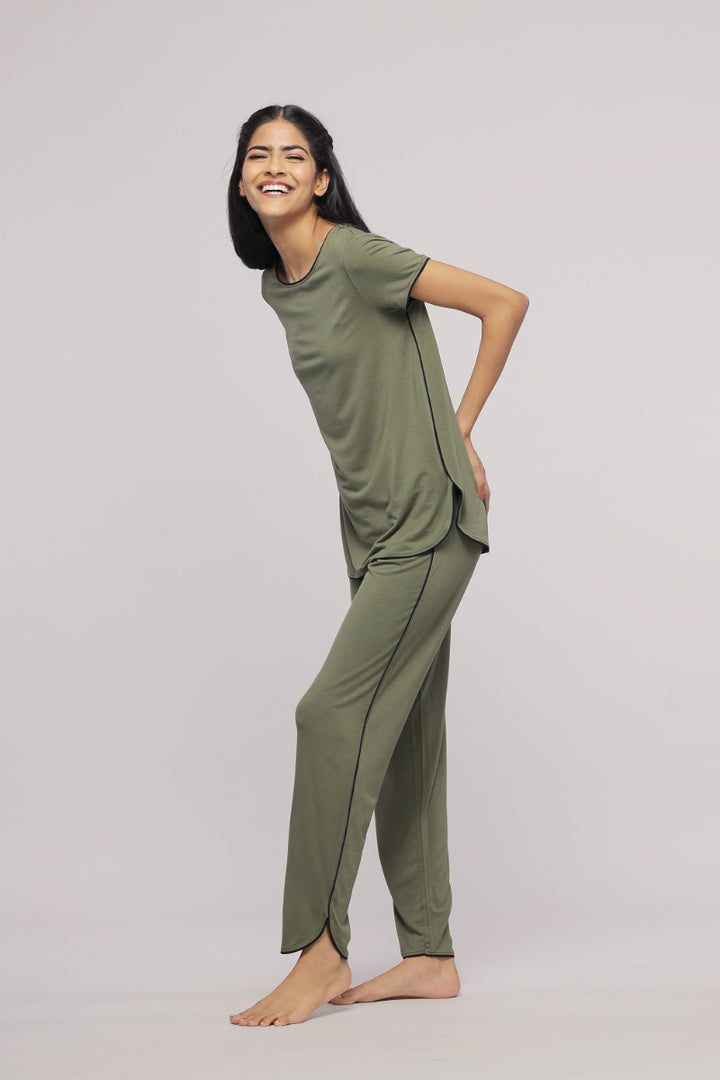 Olive green multipurpose lounge pants model smiling casually.