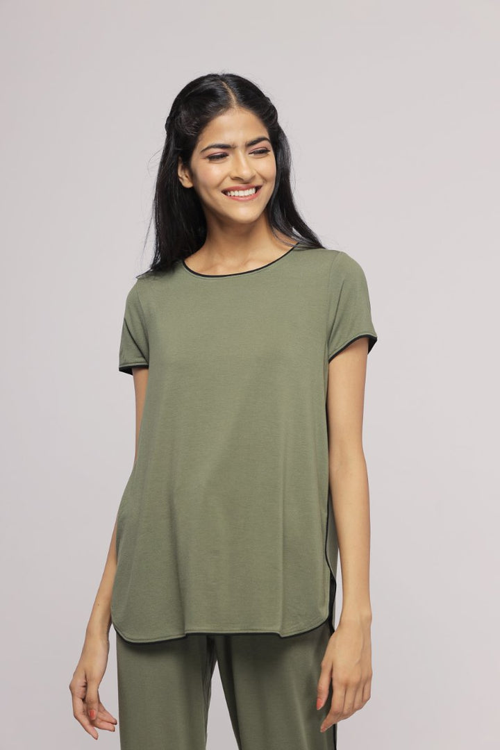 Olive green multipurpose top worn by smiling woman.