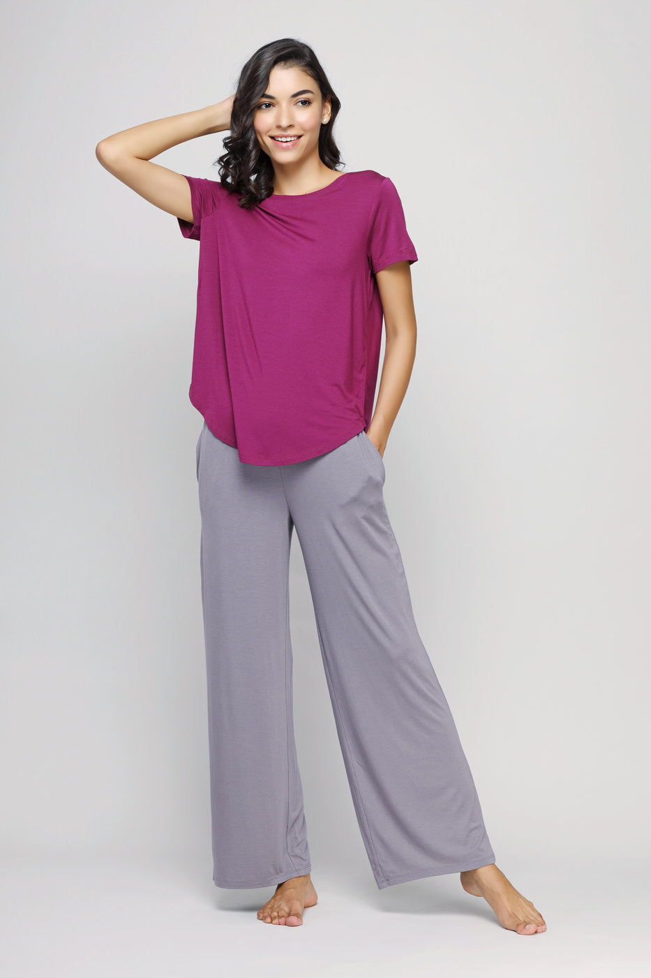 Woman wearing Wanderer Flared Lounge Set in purple and gray.