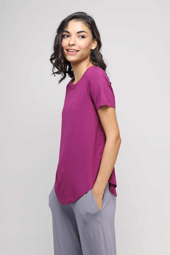 Woman wearing a Wineberry Top in a stylish purple color.