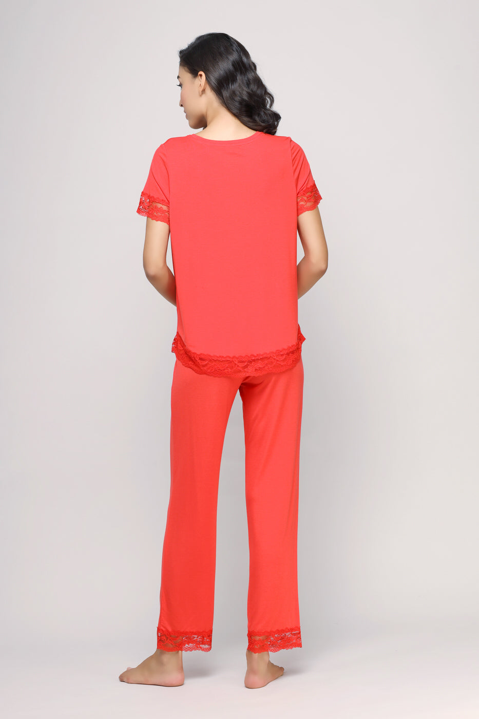 Delicate lace angel pajamas set in coral, featuring short sleeves and trousers.