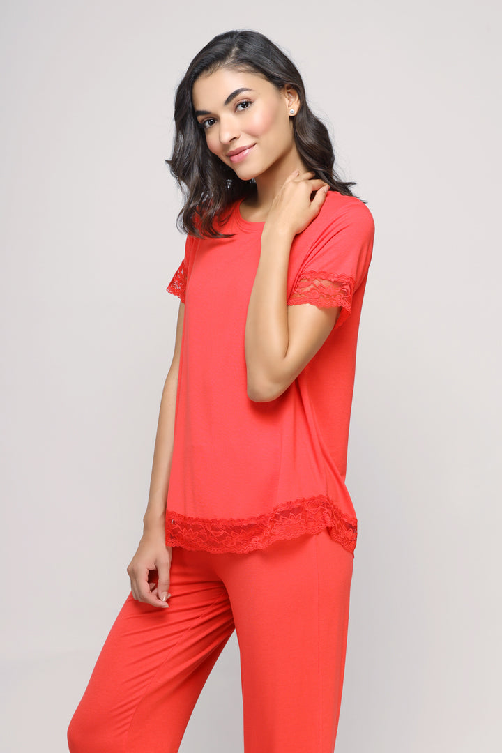 Delicate lace angel top in vibrant red, model showcasing stylish design.