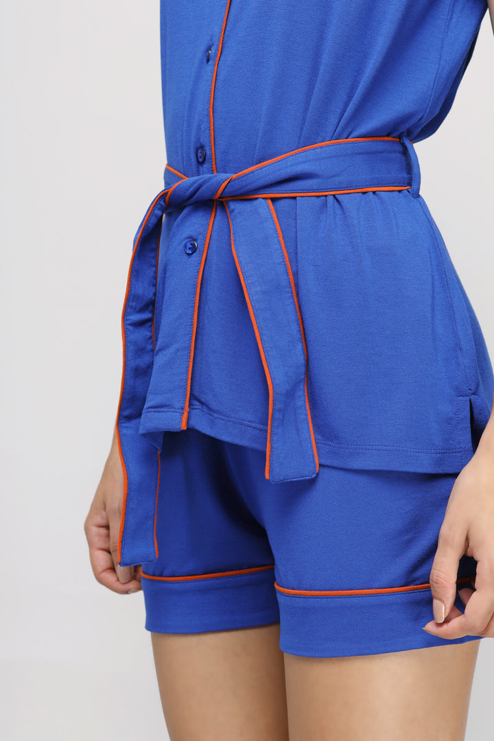 Perky blue button-down belted top with contrasting orange trim.