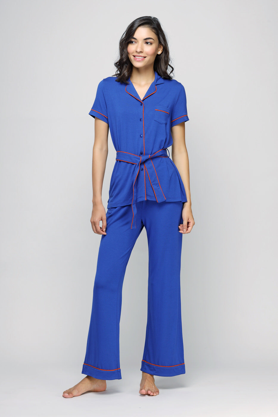 Perky blue button-down belted top with stylish red trim for women.