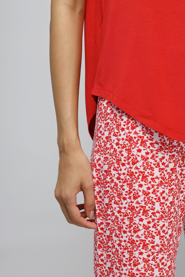 Red Love Tee styled with floral patterned pants.