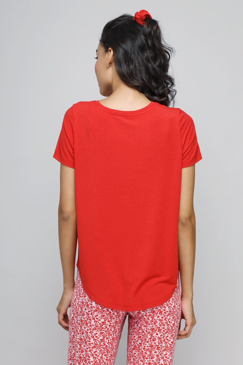 Back view of a woman wearing a red "Love Tee" shirt.