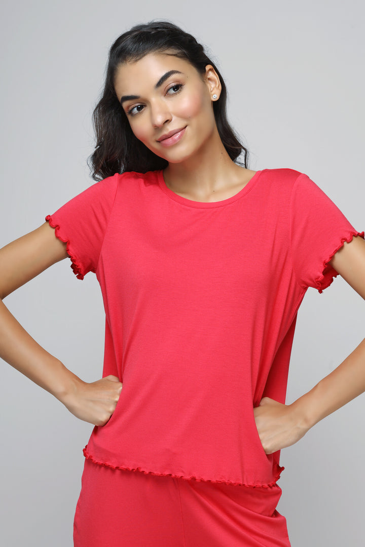 Woman wearing Love Red Frill Shorts Set, smiling in bright red outfit.