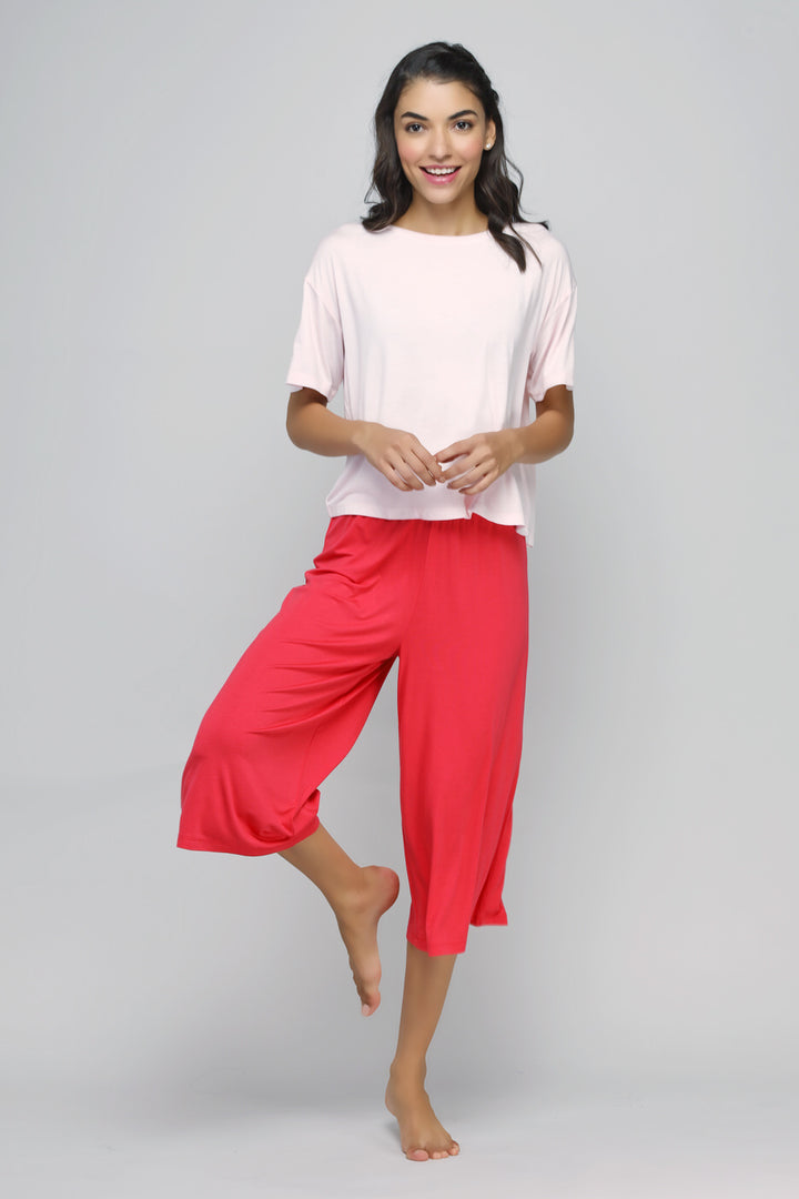 Model wearing Love Red Culottes Set with pink top and red culottes.