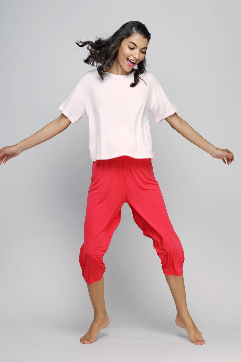 Joyful model wearing Love Red Culottes Set, showcasing vibrant red pants.