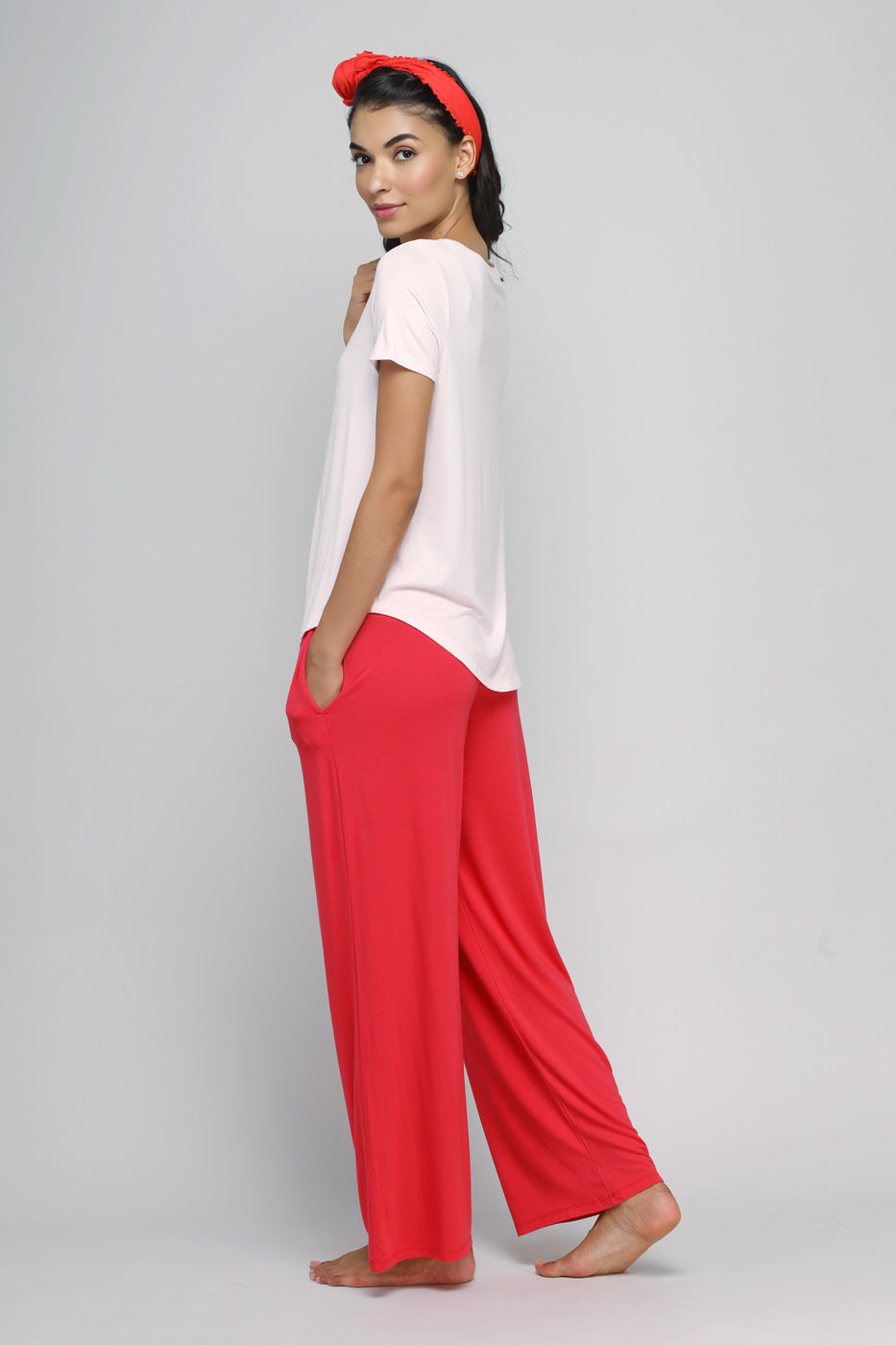 Model wearing Love Red Flared Lounge Pant with casual t-shirt and headband.